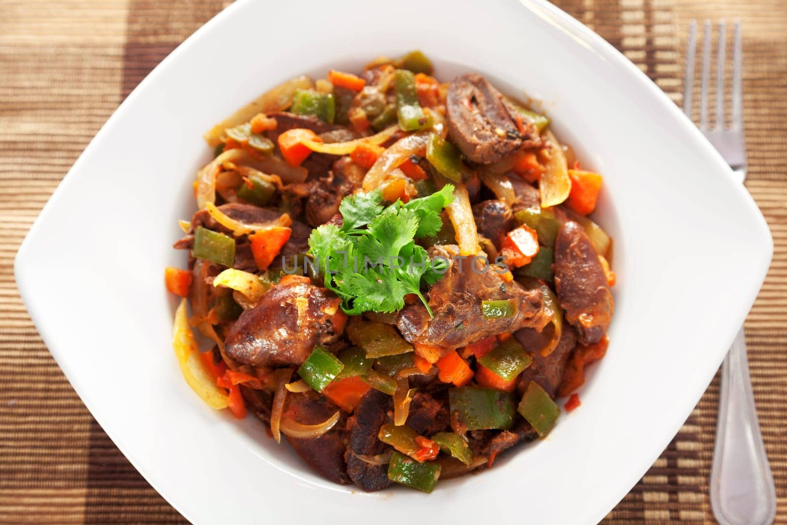 Duck hearts stew vegetables in a plate