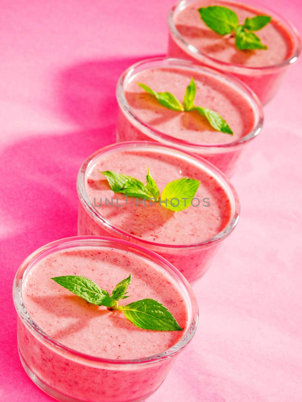 Raspberry cream with mint on pink background