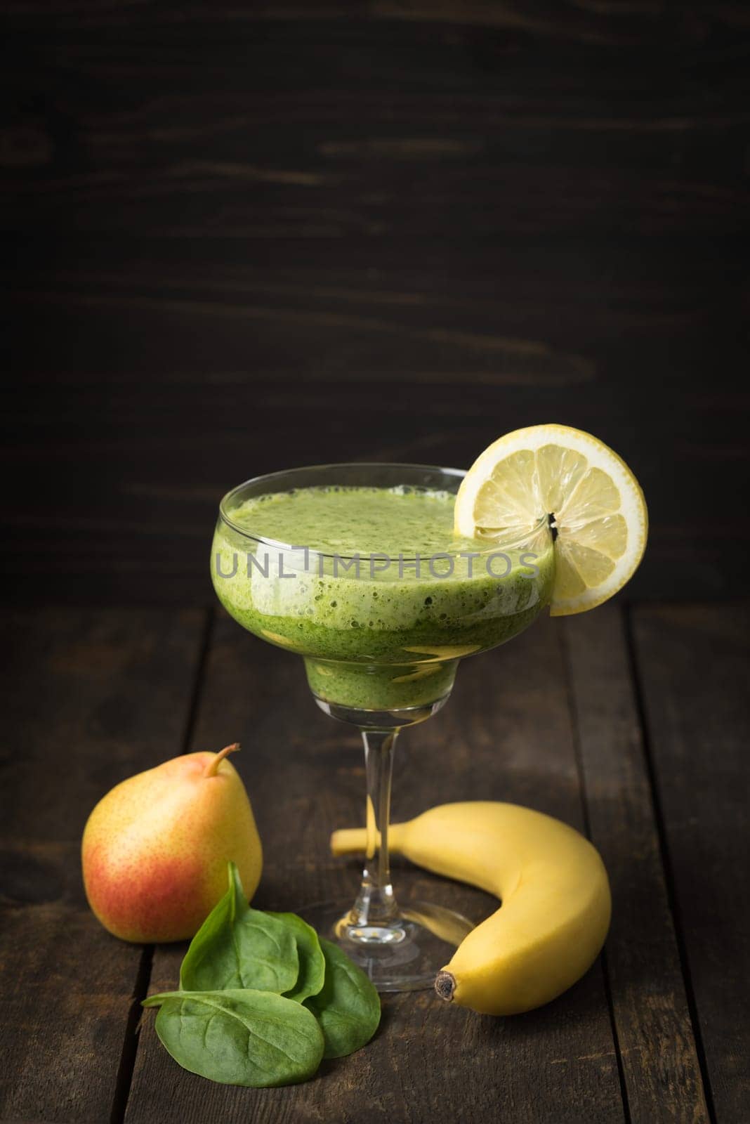 Green smoothie made from pear,banana,spinach and banana in glass