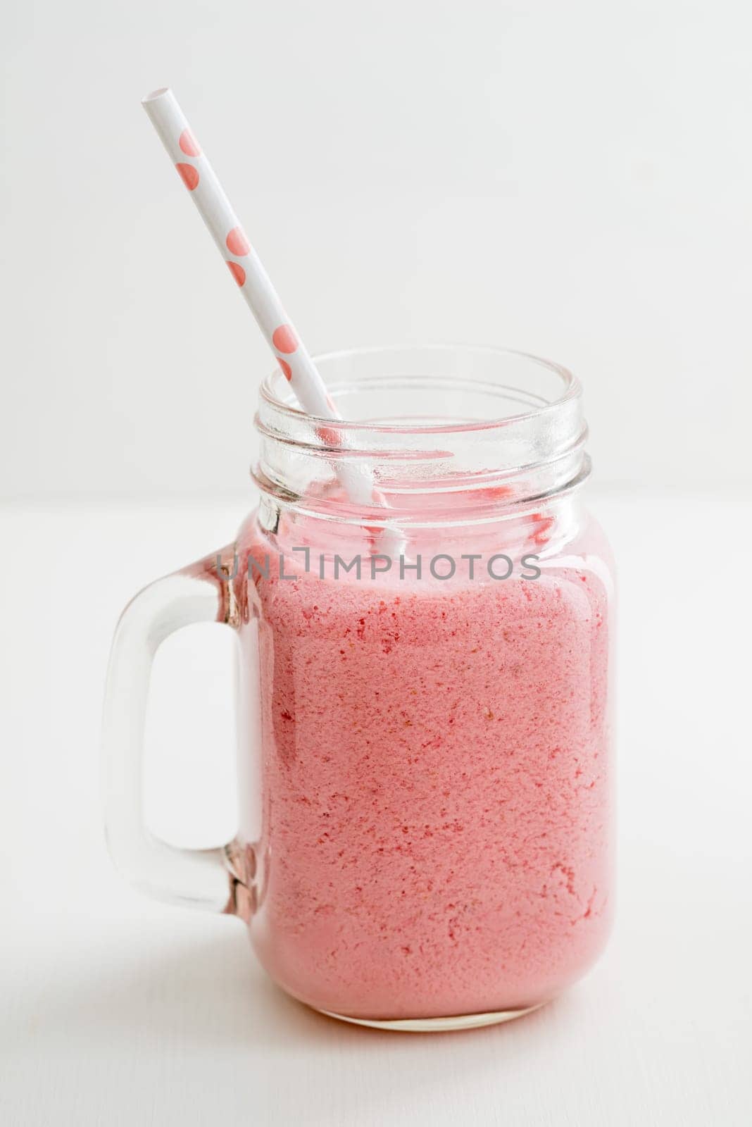 Pink healthy smoothie with yoghurt and berries