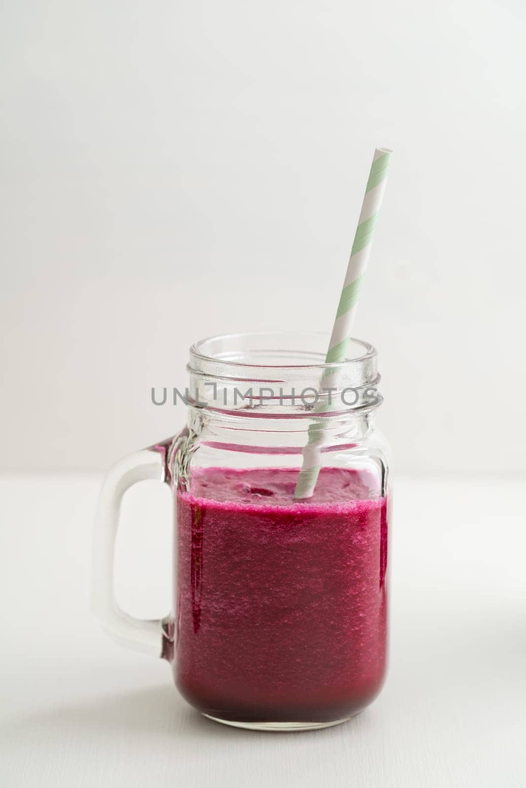 Red smoothie with beetroot and cucumber in a glass