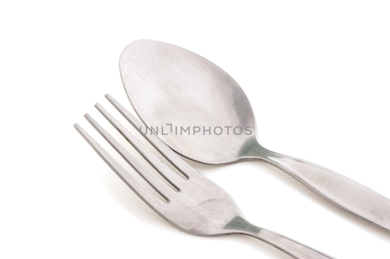 Old silver fork and spoon isolated on white background