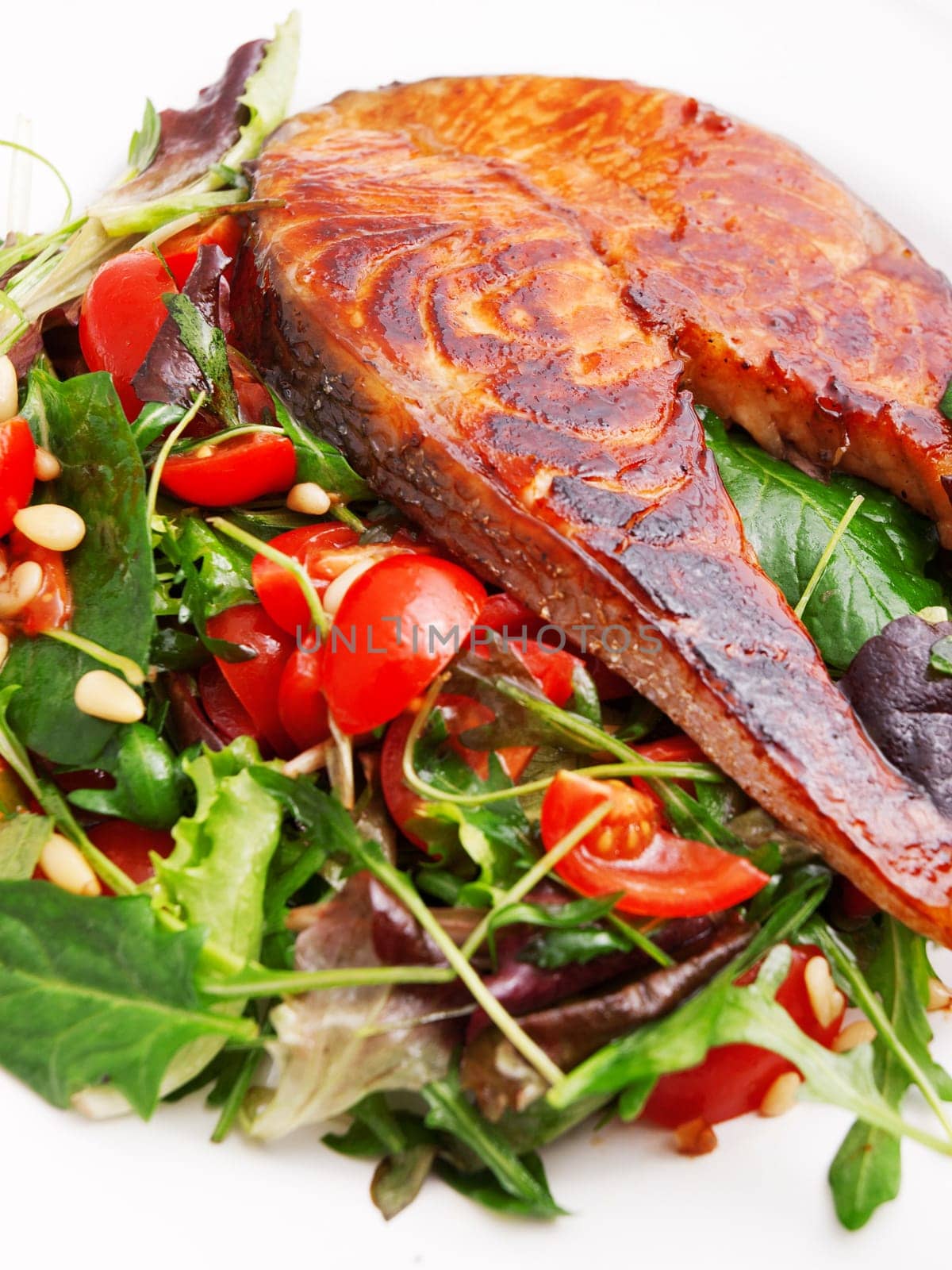 Baked marinated salmon with fresh salad of arugula and cherry tomatos