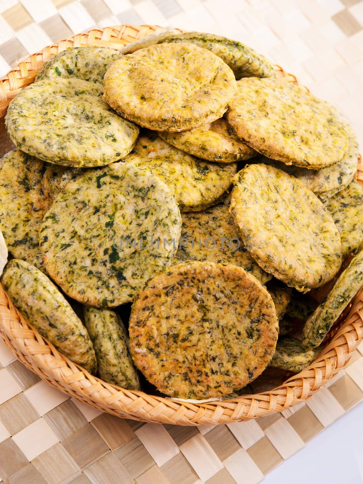 Homemade biscuits with spinach in a basket, close up