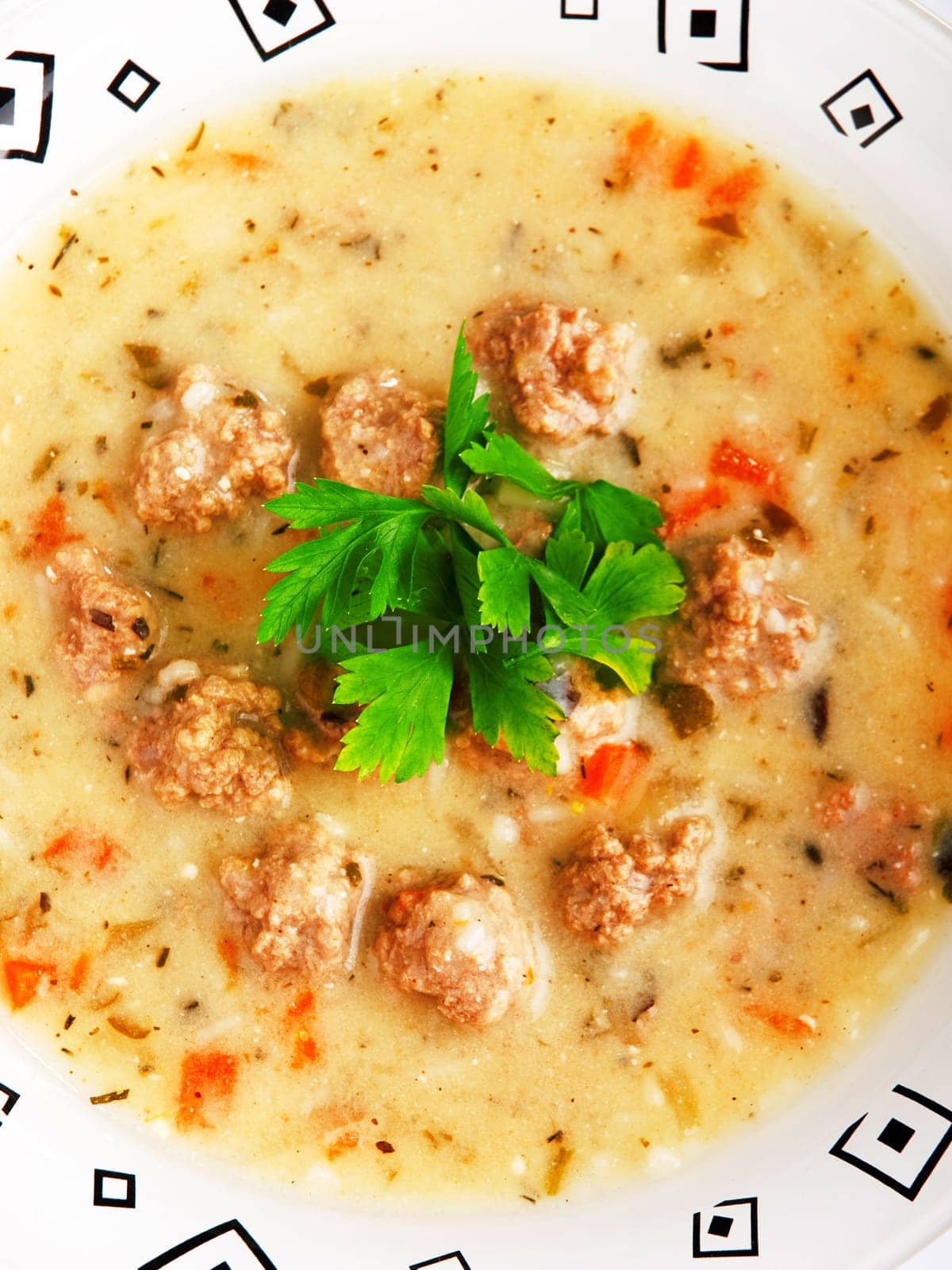 Portion of soup with meatballs in a plate