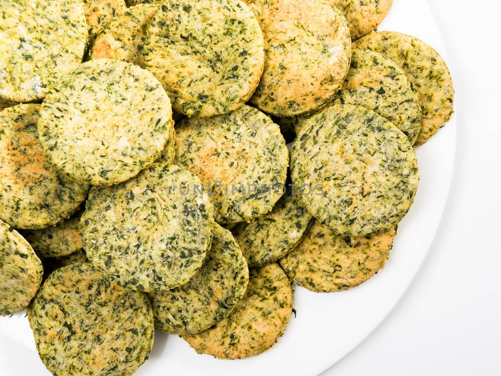 Homemade biscuits with spinach in a basket, close up