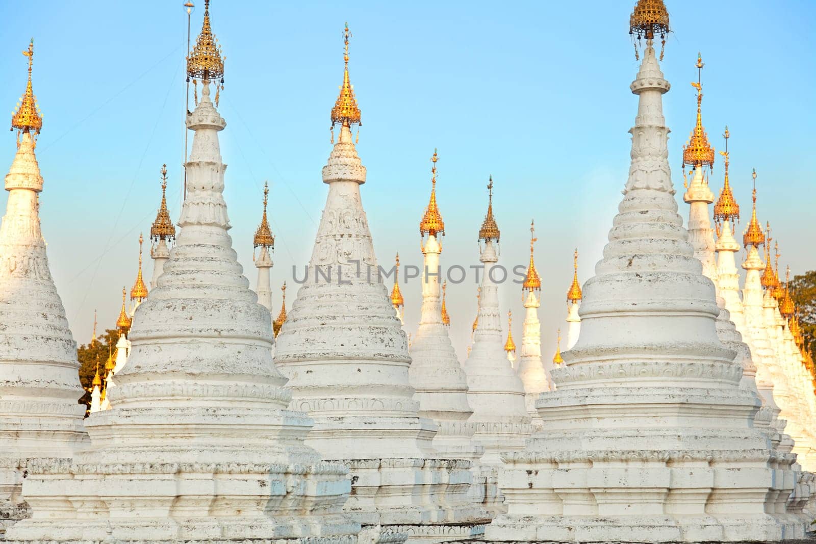Kuthodaw Pagoda is a Buddhist stupa, located in Mandalay, Burma (Myanmar), that contains the world's largest book. It lies at the foot of Mandalay Hill. In the grounds of the pagoda are 729 stone-inscription caves, each containing a marble slab inscribed on both sides with a page of text from the Tipitaka, the entire Pali Canon of Theravada Buddhism. Pagoda Kuthodaw stretching from 1860 to 1868 during the reign of King Mindona.
