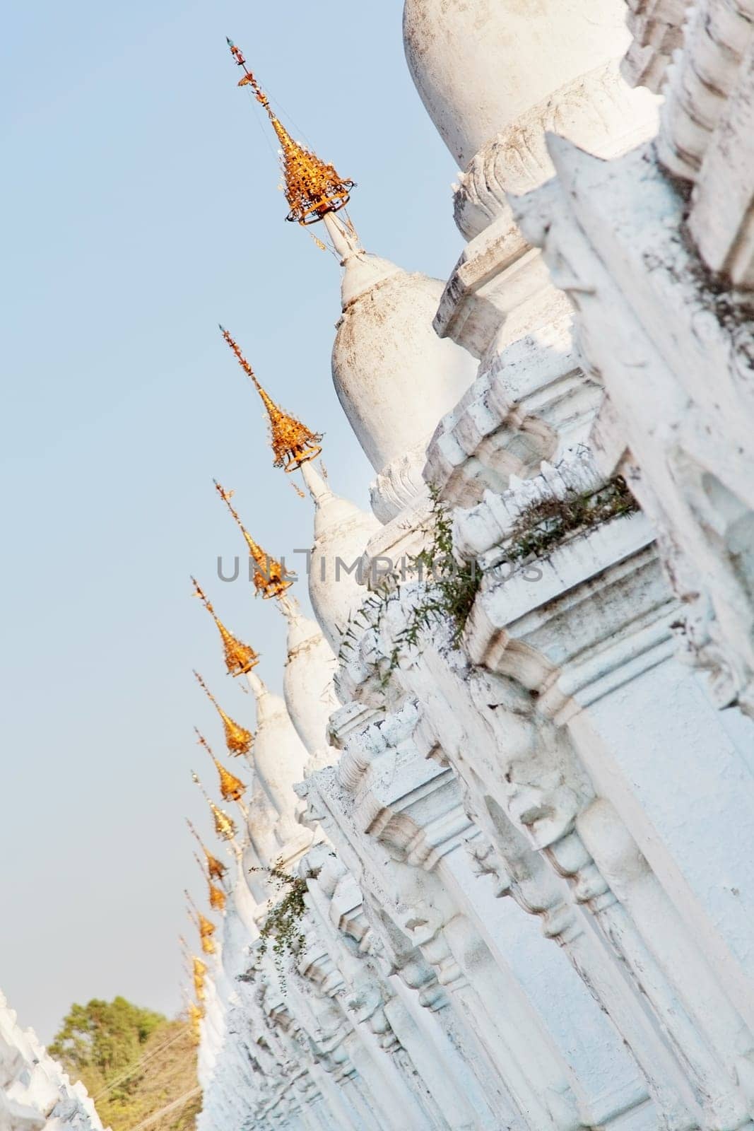 Kuthodaw Pagoda is a Buddhist stupa, located in Mandalay, Burma (Myanmar), that contains the world's largest book. It lies at the foot of Mandalay Hill. In the grounds of the pagoda are 729 stone-inscription caves, each containing a marble slab inscribed on both sides with a page of text from the Tipitaka, the entire Pali Canon of Theravada Buddhism. Pagoda Kuthodaw stretching from 1860 to 1868 during the reign of King Mindona.
