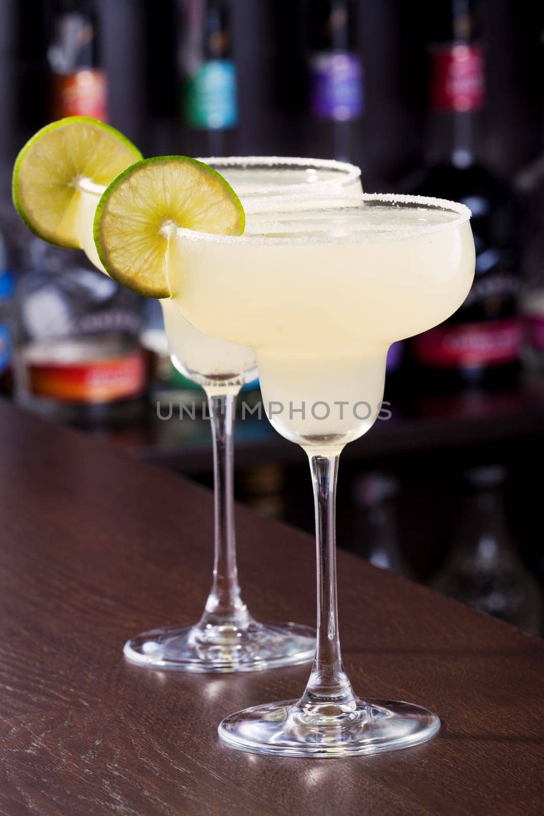 The margarita is a cocktail consisting of tequila mixed with orange-flavoured liqueur and lime or lemon juice, often served with salt on the glass rim.The drink is served shaken with ice, on the rocks, blended with ice (frozen margarita) or without ice (straight up)...Ingredients