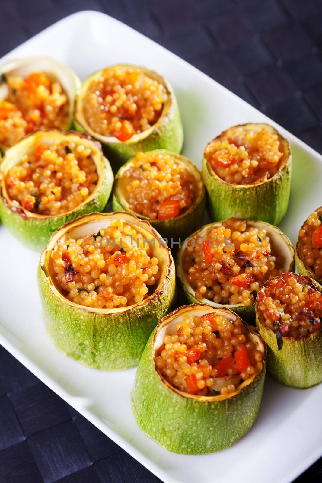 Zucchini stuffed with couscous served in a plate