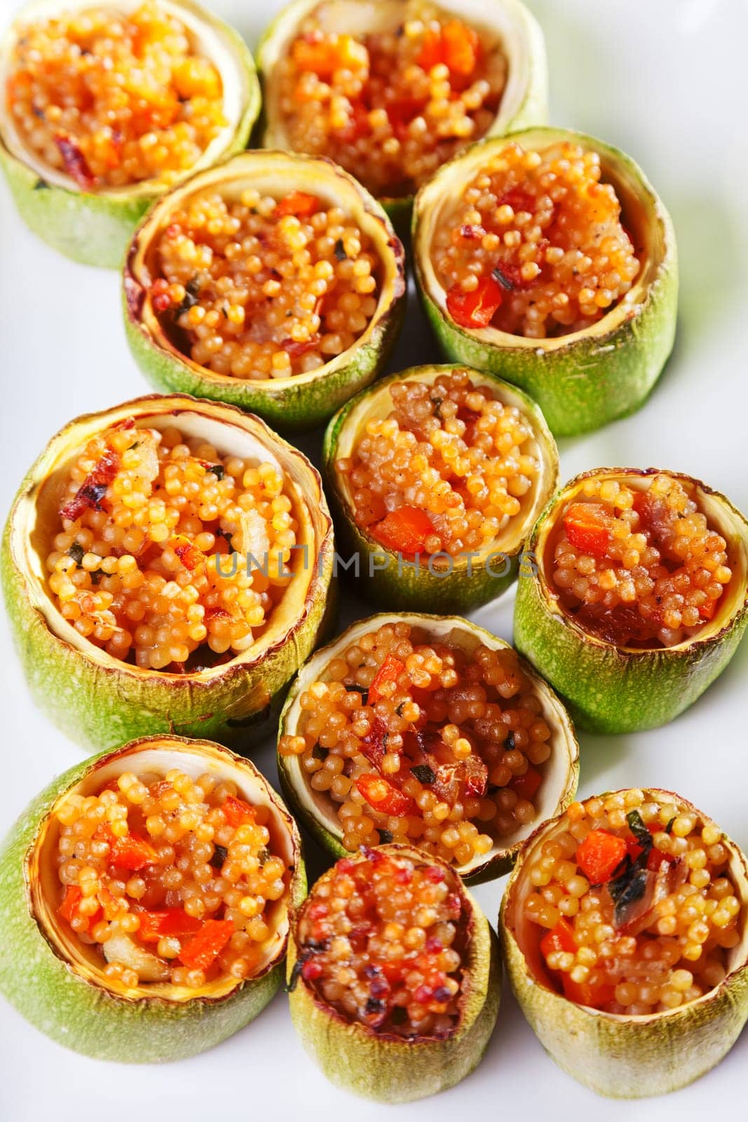 Zucchini stuffed with couscous served in a plate