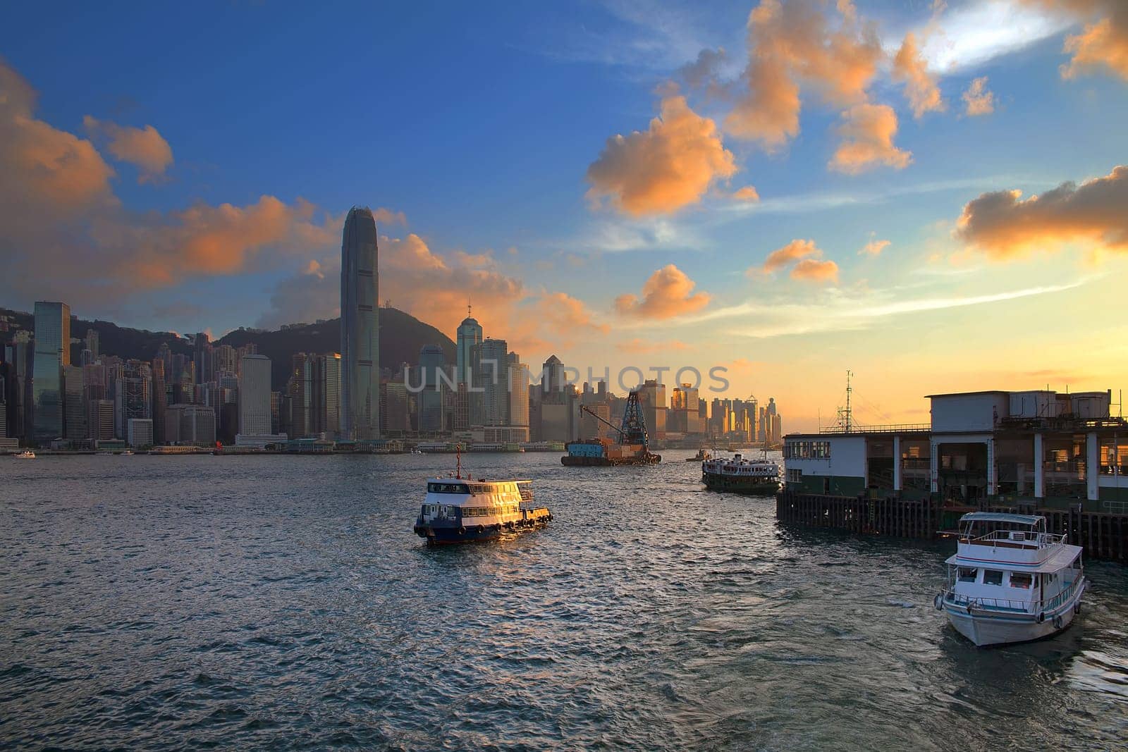 Hong Kong Island Central City Skyline from Kowloon Ferry Pier Along Victoria Harbor Sunset