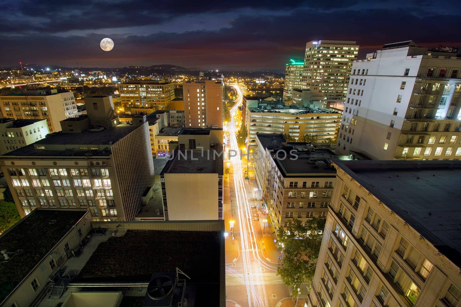 Full Moon Rising Over Portland Oregon Cityscape with Long Exposure Traffic Light Trails on Southwest Washington Street