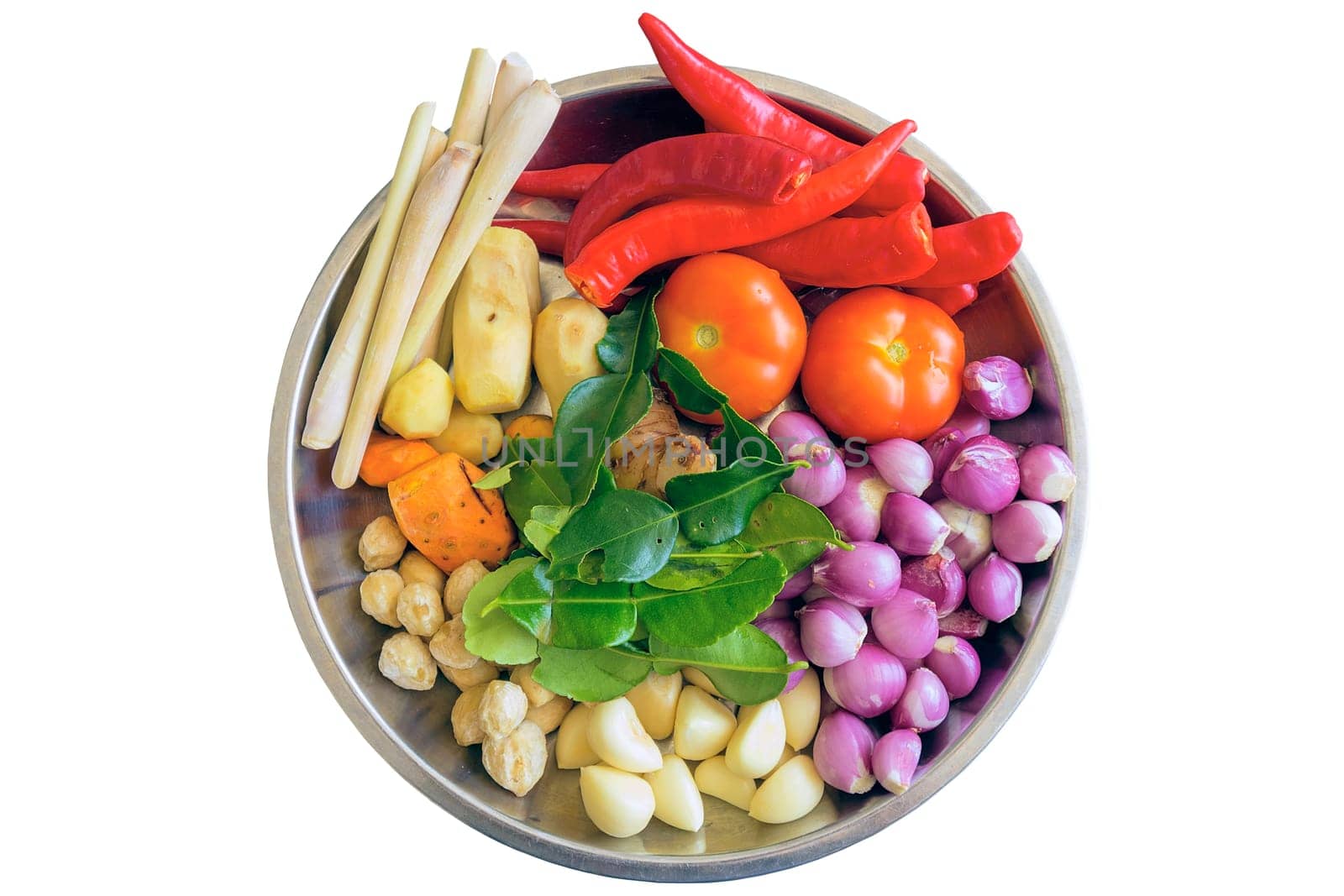 Fresh Ingredients for Cooking Southeast Asian Curry Dish Sauce with Chili Peppers Turmeric Ginger Lemon Grass Onions Shallots Lime Leaves Garlic Candlenut Tomato