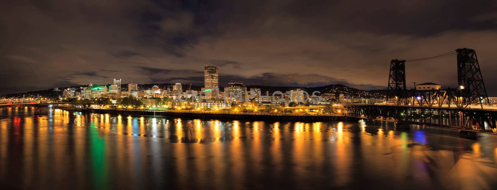 Portland Oregon Downtown City Skyline and Bridges Along Willamette River Waterfront at Night with Storm Clouds Panorama