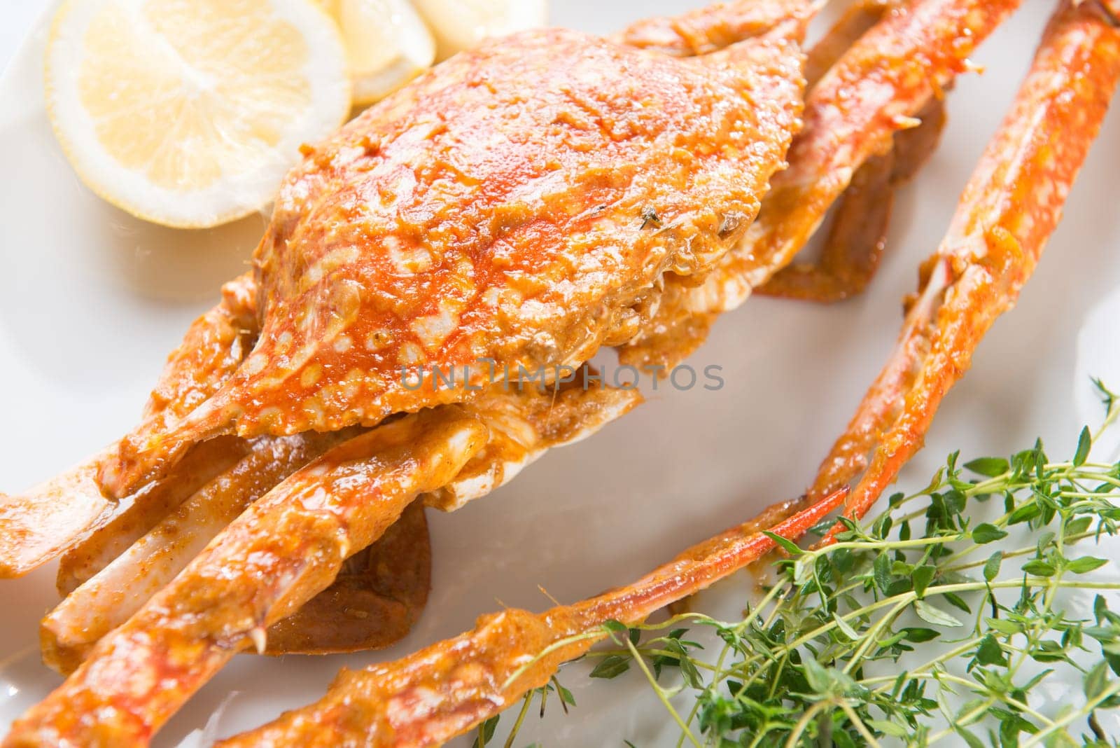 Close up cooked delicious hot and spicy sauce blue crab, on white plate. Fresh cook with hot smoke steams.