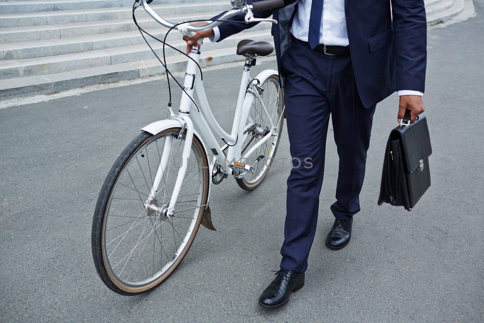 Businessman with briefcase and bicycle going to work