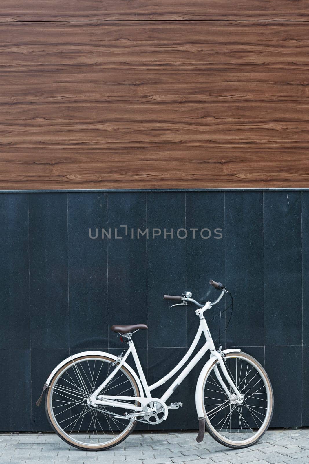 Bicycle by wall of modern building