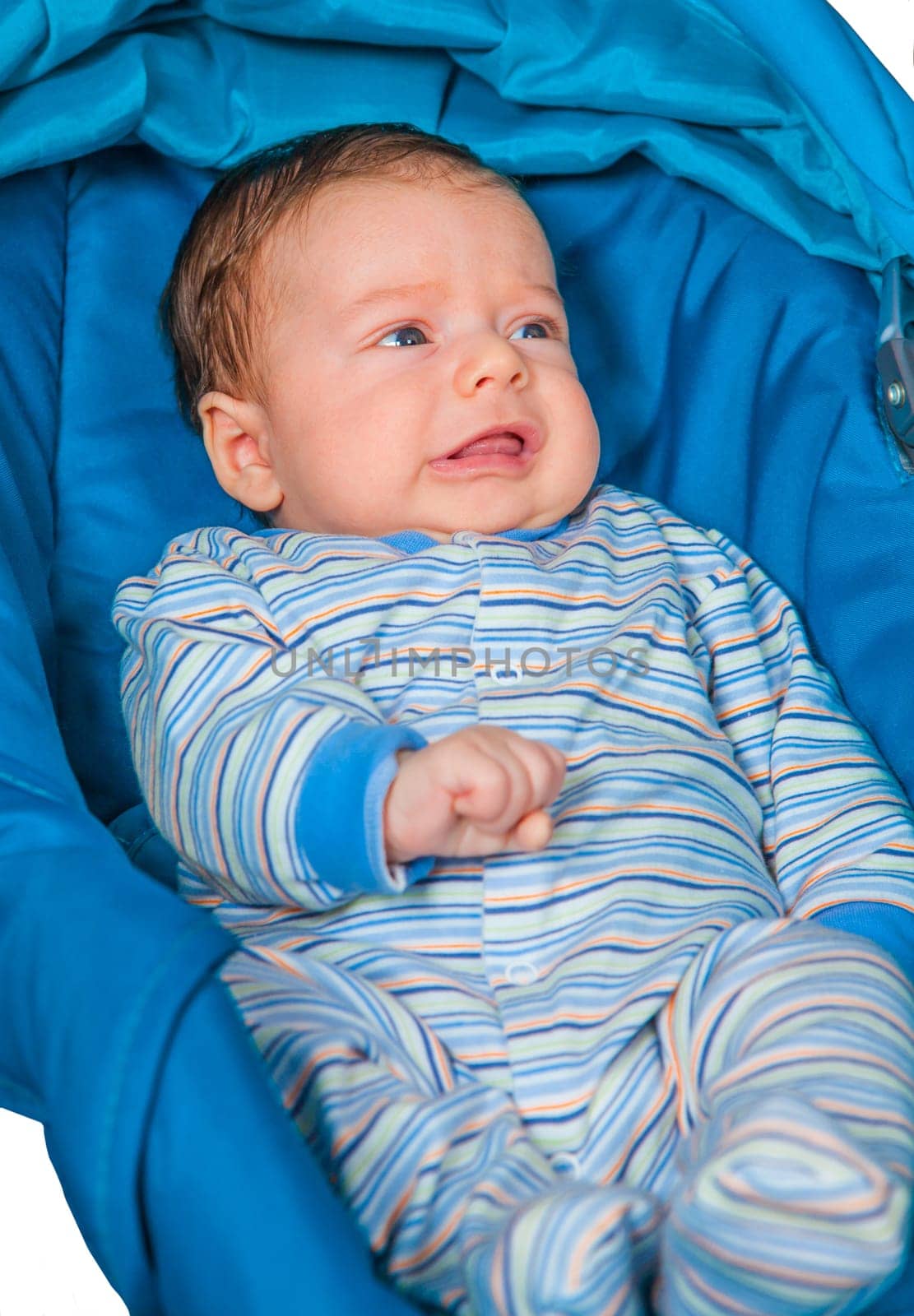 Portrait of a 2 months old baby boy sitting in a safety seat.