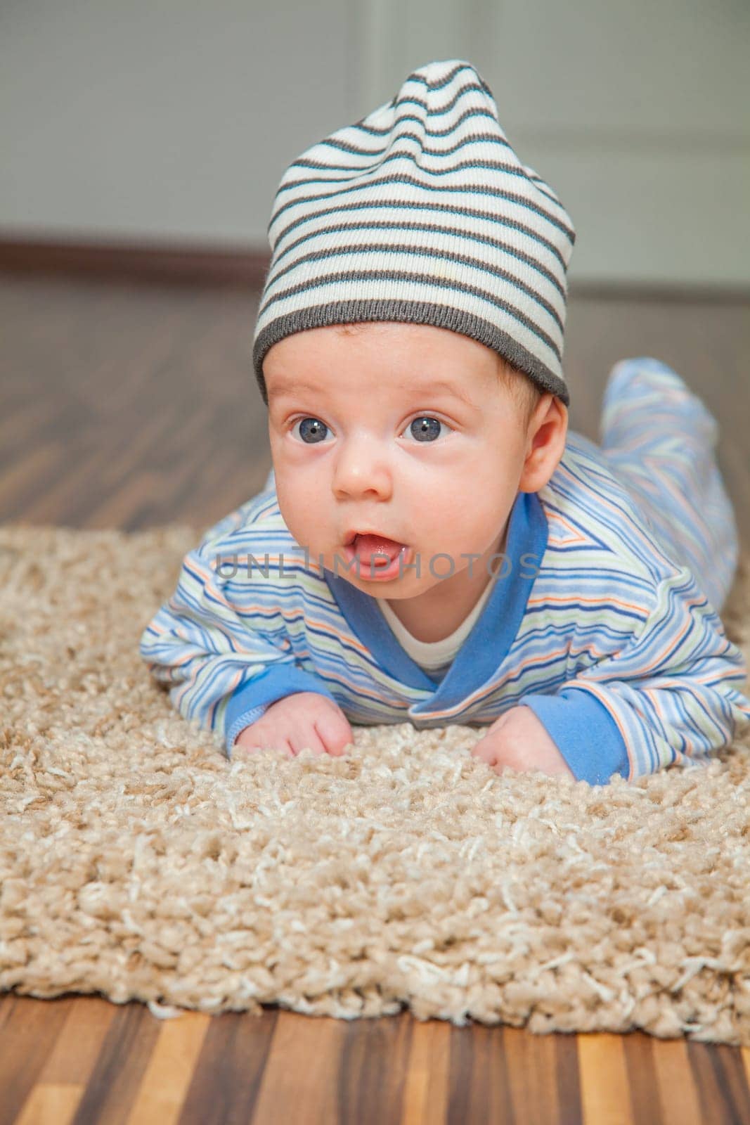 Portrait of a 2 months old baby boy at his home.