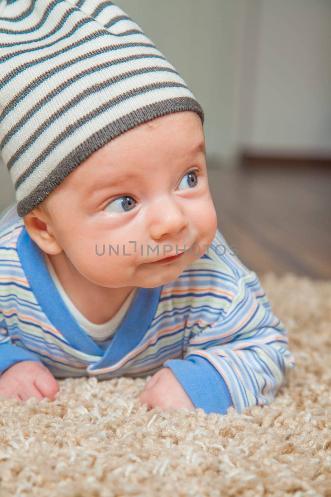 Portrait of a 2 months old baby boy at his home.