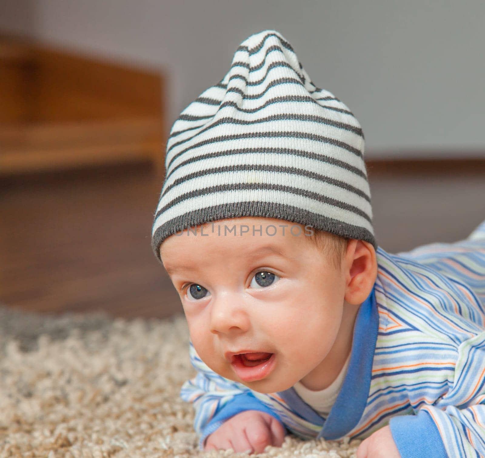 Portrait of a 2 months old baby boy at his home.