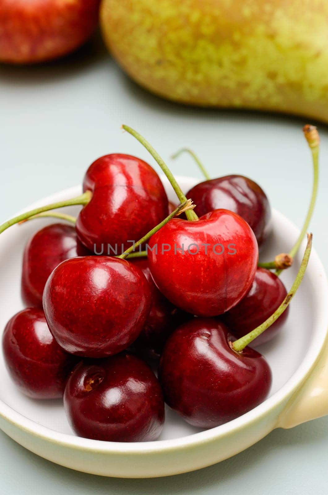 Sweet cherries in a bowl on a kitchen table