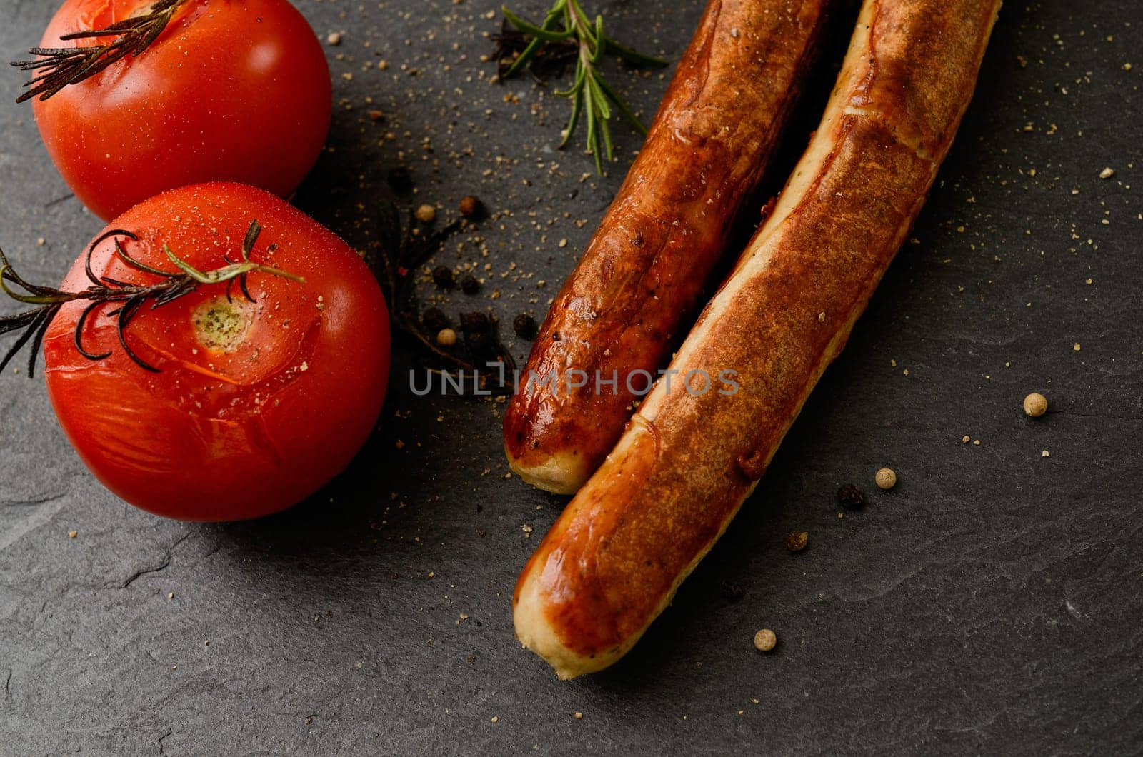 Roasted tomatoes with rosemary and grilled sausages