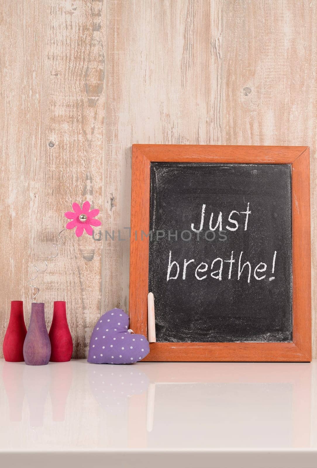 chalkboard with the words Just breathe, wellness and health care concept