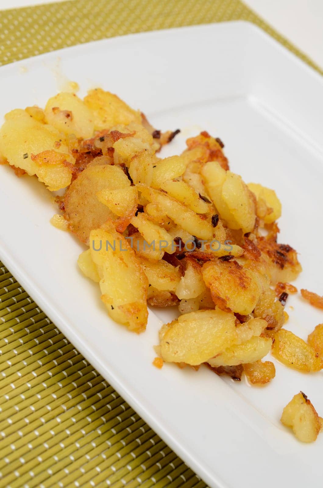 Roasted potatoes on a white plate