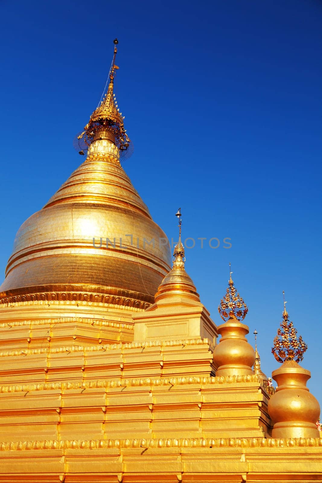 The Maha Lawka Marazein Pagoda at the center of the Kuthodaw Pagoda. Kuthodaw Pagoda is a Buddhist stupa, located in Mandalay, Burma (Myanmar), that contains the world's largest book. It lies at the foot of Mandalay Hill. In the grounds of the pagoda are 729 stone-inscription caves, each containing a marble slab inscribed on both sides with a page of text from the Tipitaka, the entire Pali Canon of Theravada Buddhism. Pagoda Kuthodaw stretching from 1860 to 1868 during the reign of King Mindona.