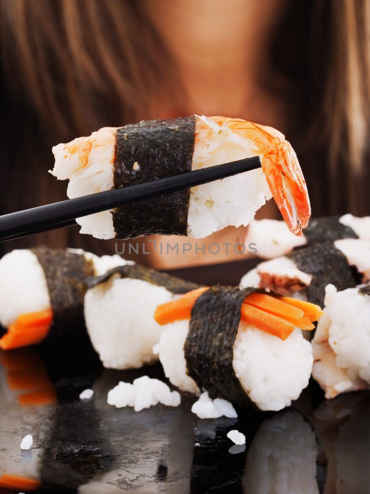 Girl eating sushi, close up