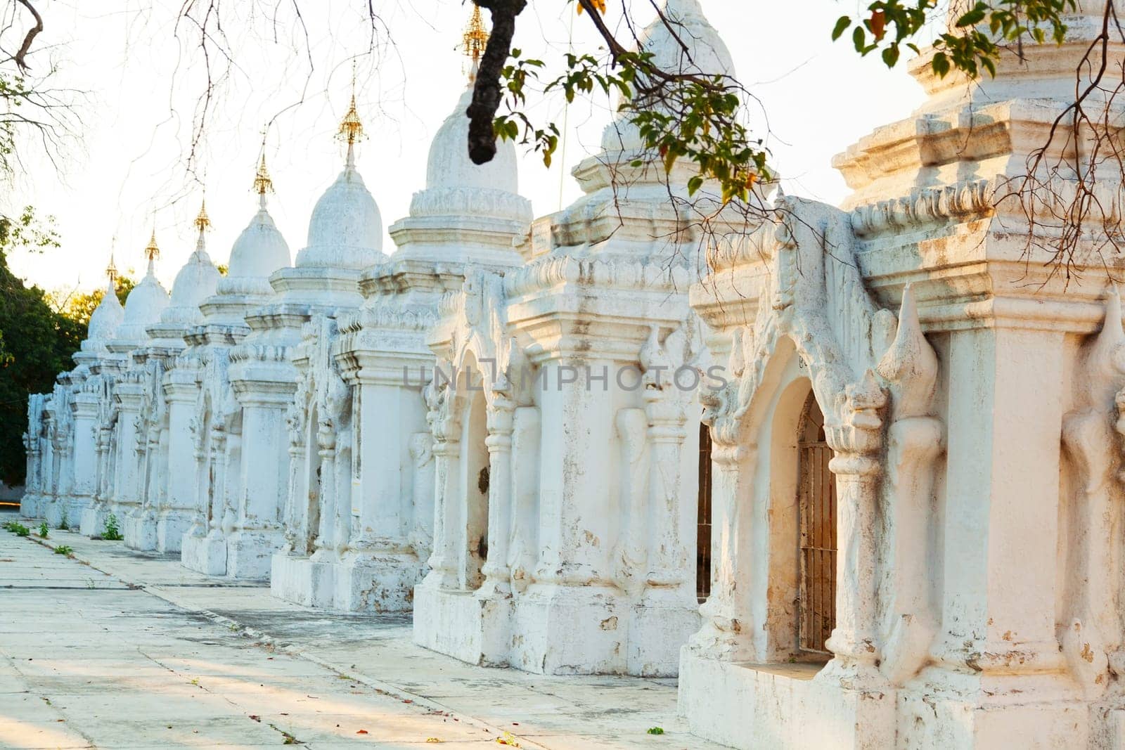 Kuthodaw Pagoda is a Buddhist stupa, located in Mandalay, Burma (Myanmar), that contains the world's largest book. It lies at the foot of Mandalay Hill. In the grounds of the pagoda are 729 stone-inscription caves, each containing a marble slab inscribed on both sides with a page of text from the Tipitaka, the entire Pali Canon of Theravada Buddhism. Pagoda Kuthodaw stretching from 1860 to 1868 during the reign of King Mindona.