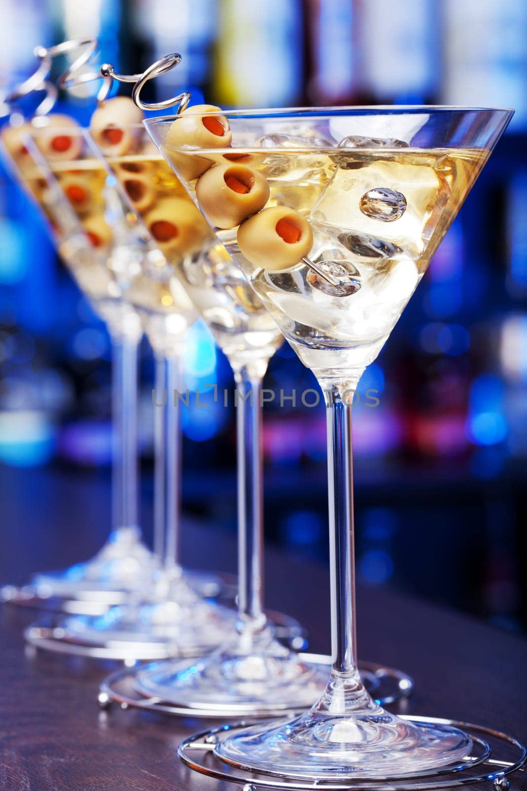 Several glasses of famous cocktail Martini, shot at a bar with shallow depth of field..Ingredients