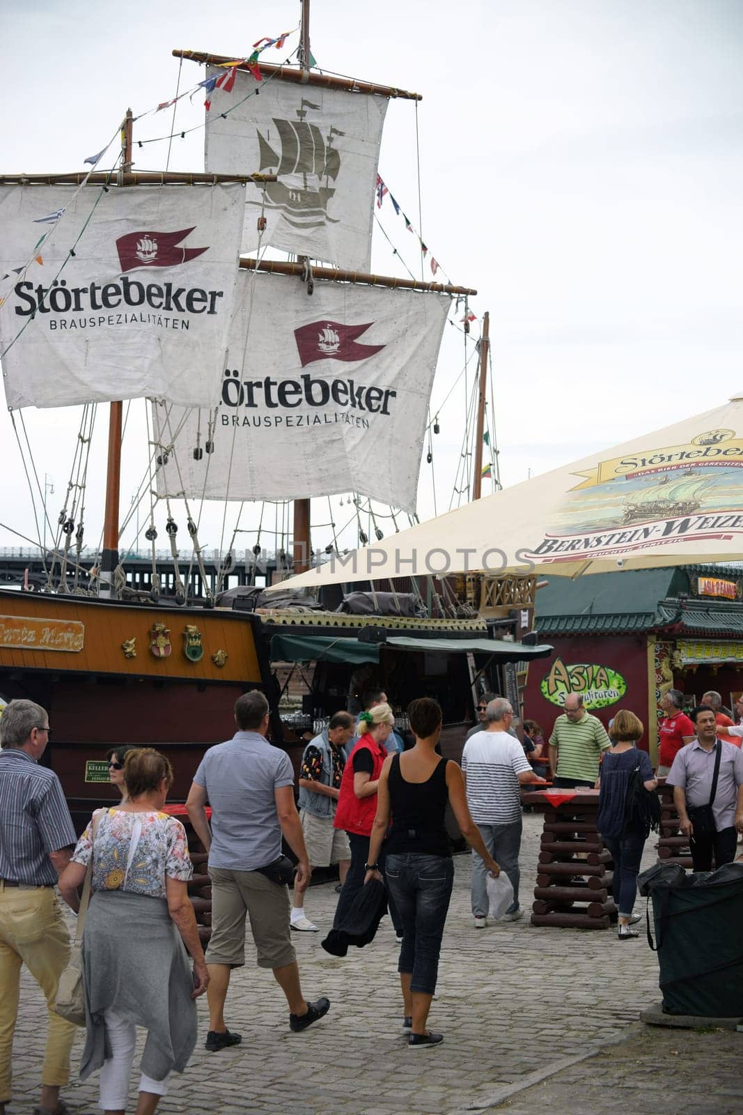 Mainz,Germany – July 11,2015: Passers-by and visitors to the summer festival Mainzer Bierbörse pass the stall of the Störtebeker Brauspezialitäten Brewery on July 11,2015 in Mainz.