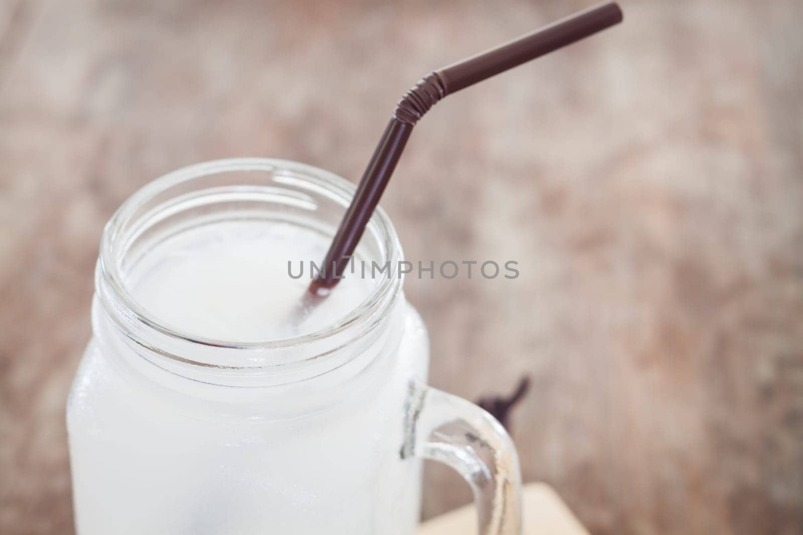 Glass of fresh coconut water, stock photo
