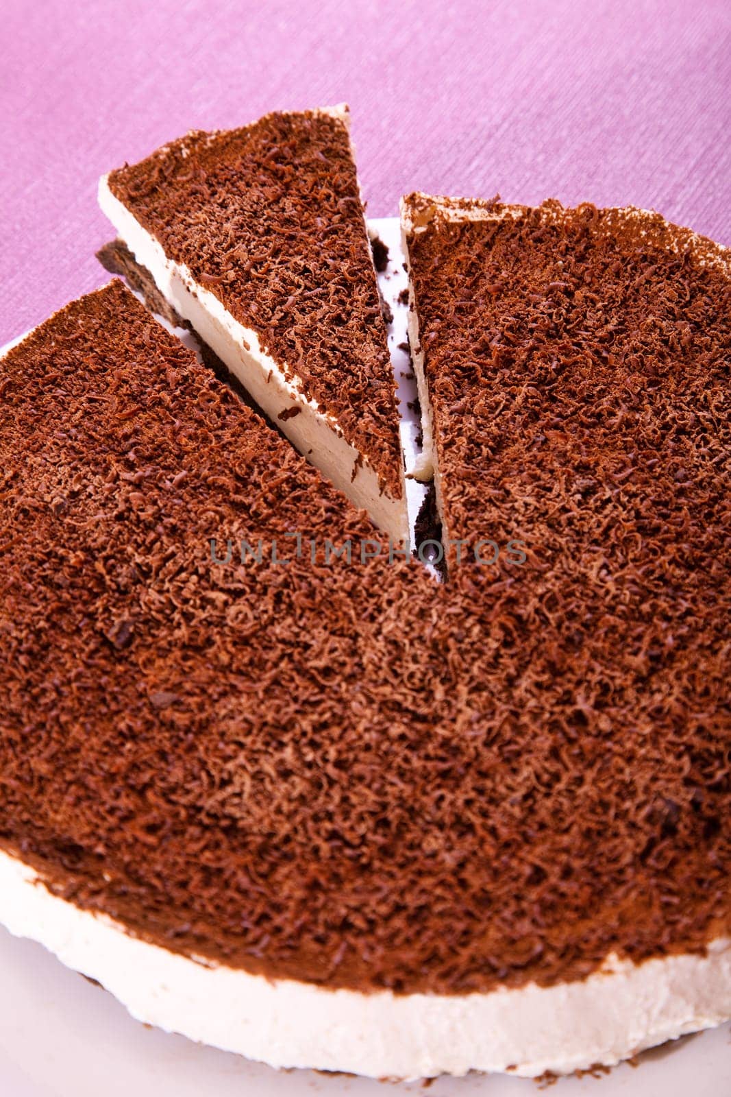 Chocolate cheesecake with one piece cut