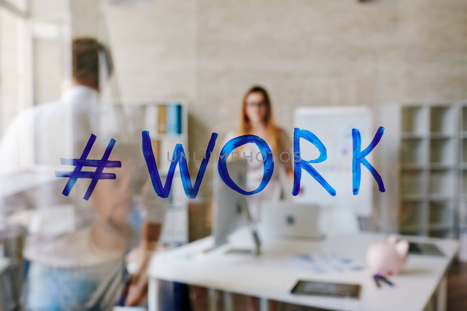 Hashtag for ‘work’ on transparent board in office