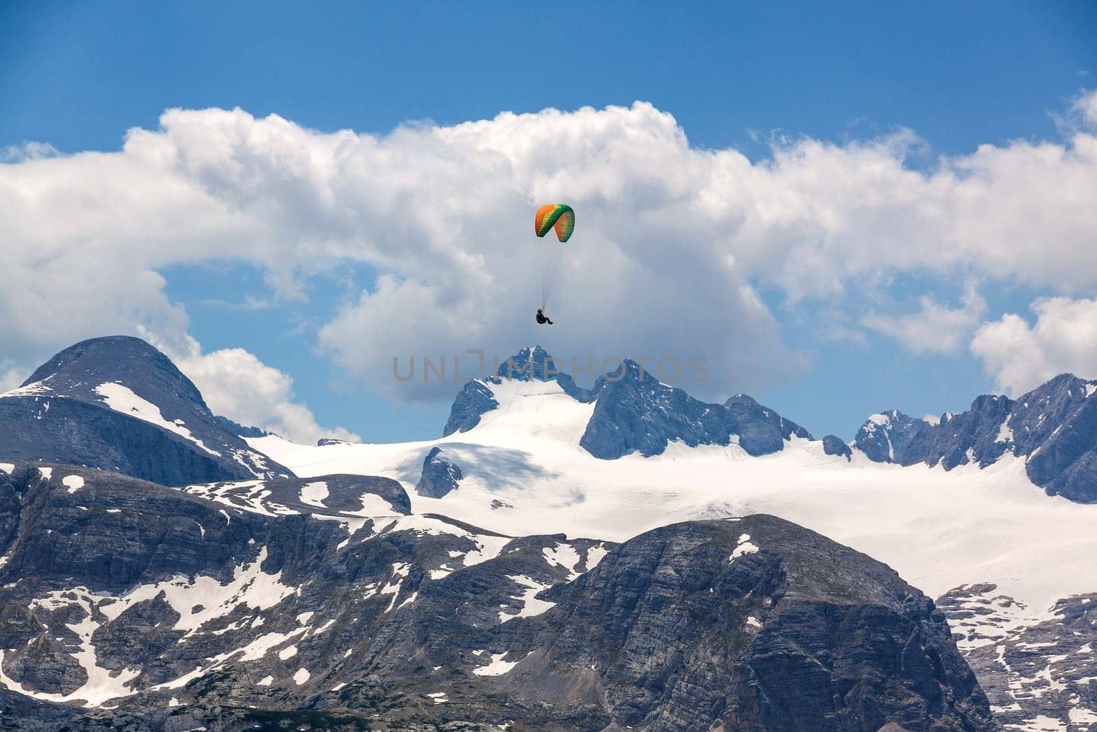 Paraglider at the sky over the Dachstein mountains
