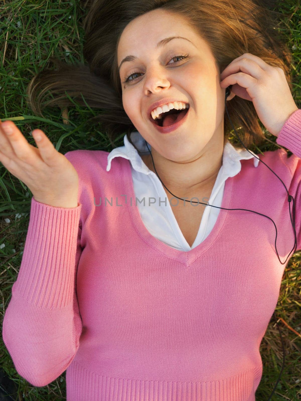 Woman listening to music on the grass