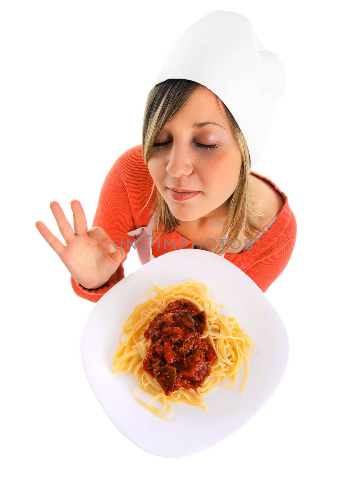 Cheff with spaghetti bolognese isolated on white, expressing positivity, licking her lips