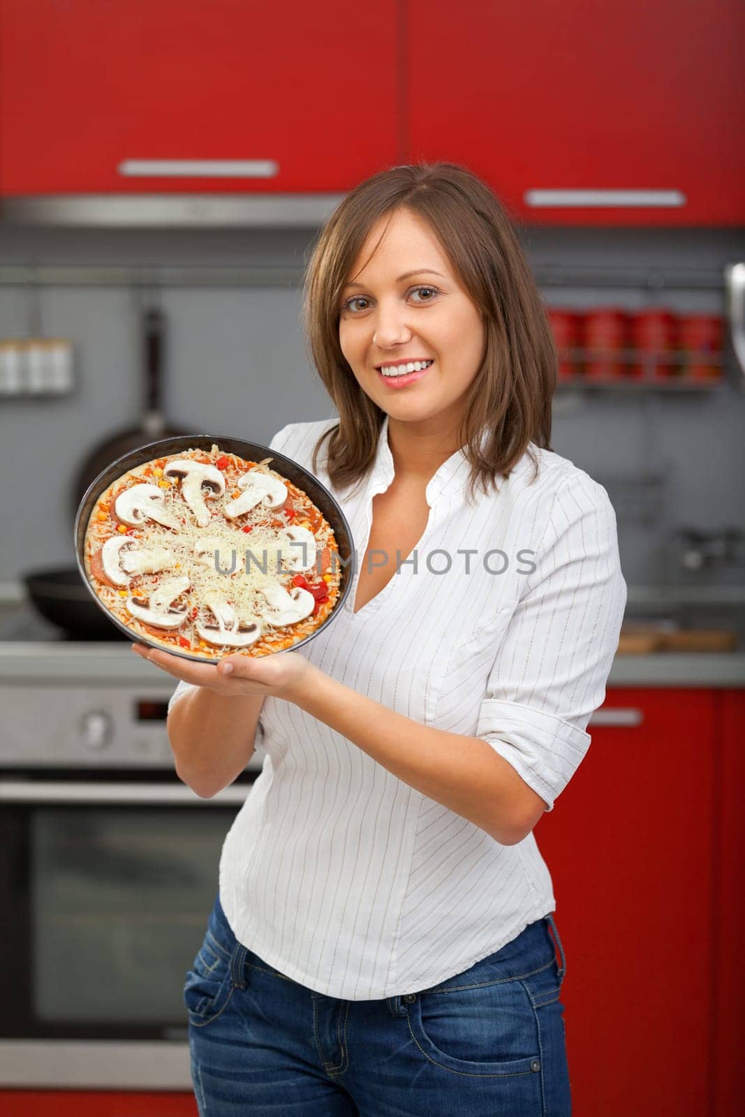 Young woman preparing homemade pizza - just before baking it