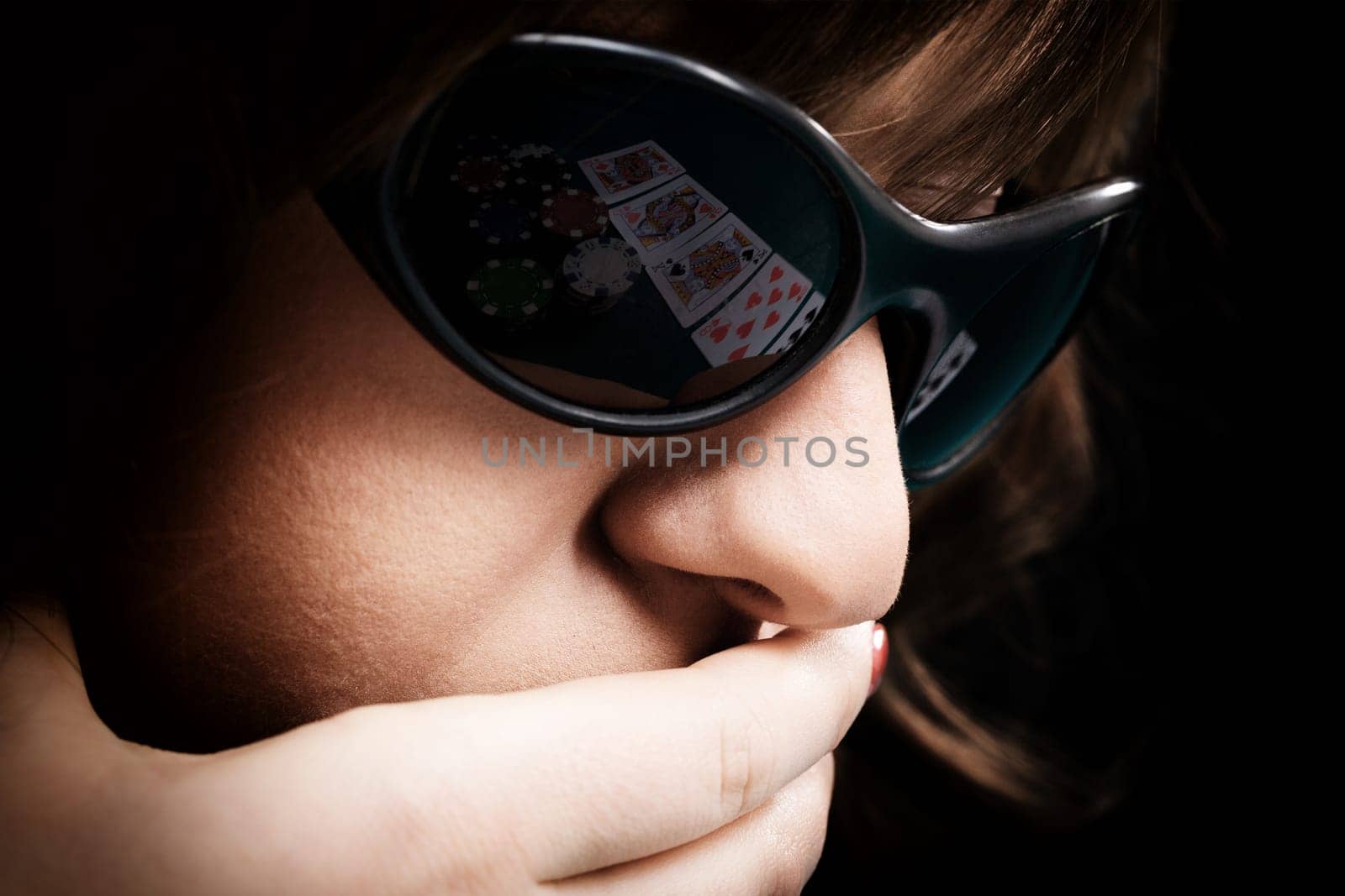 Young woman with black sunglasses reflecting cards