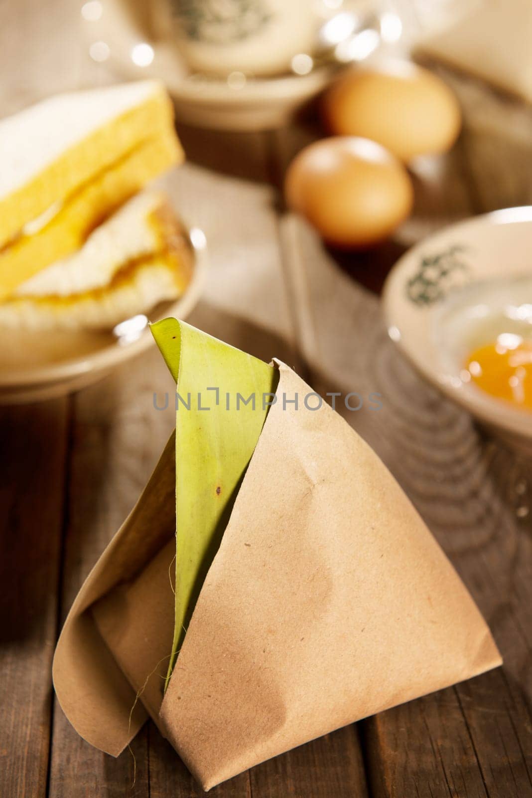 Traditional Malaysian kopitiam style breakfast and coffee. Fractal on the cup is generic print. Soft focus setting with dramatic ambient light on dark wooden background.