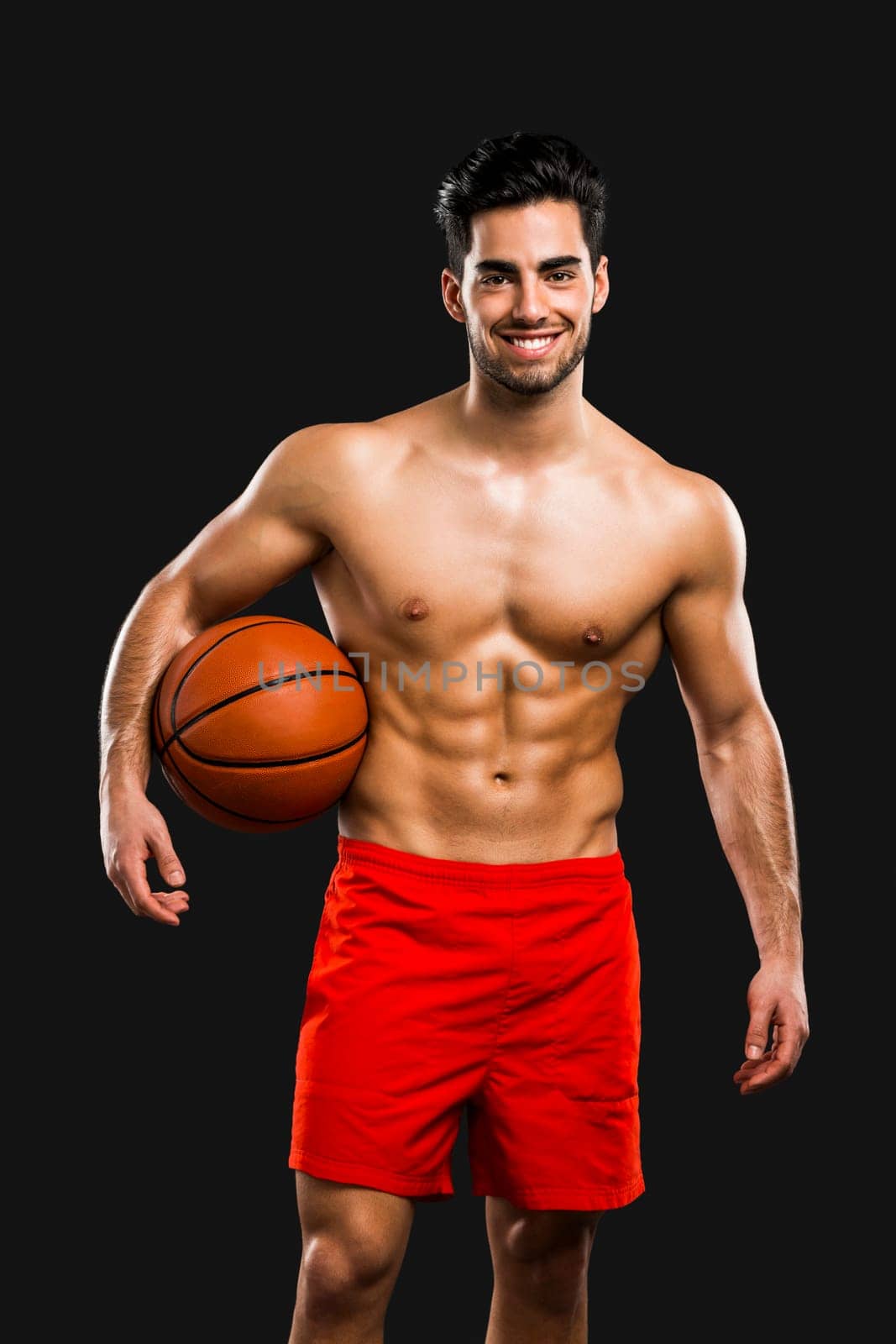 Handsome and sexy muscular man, isolated over gray background