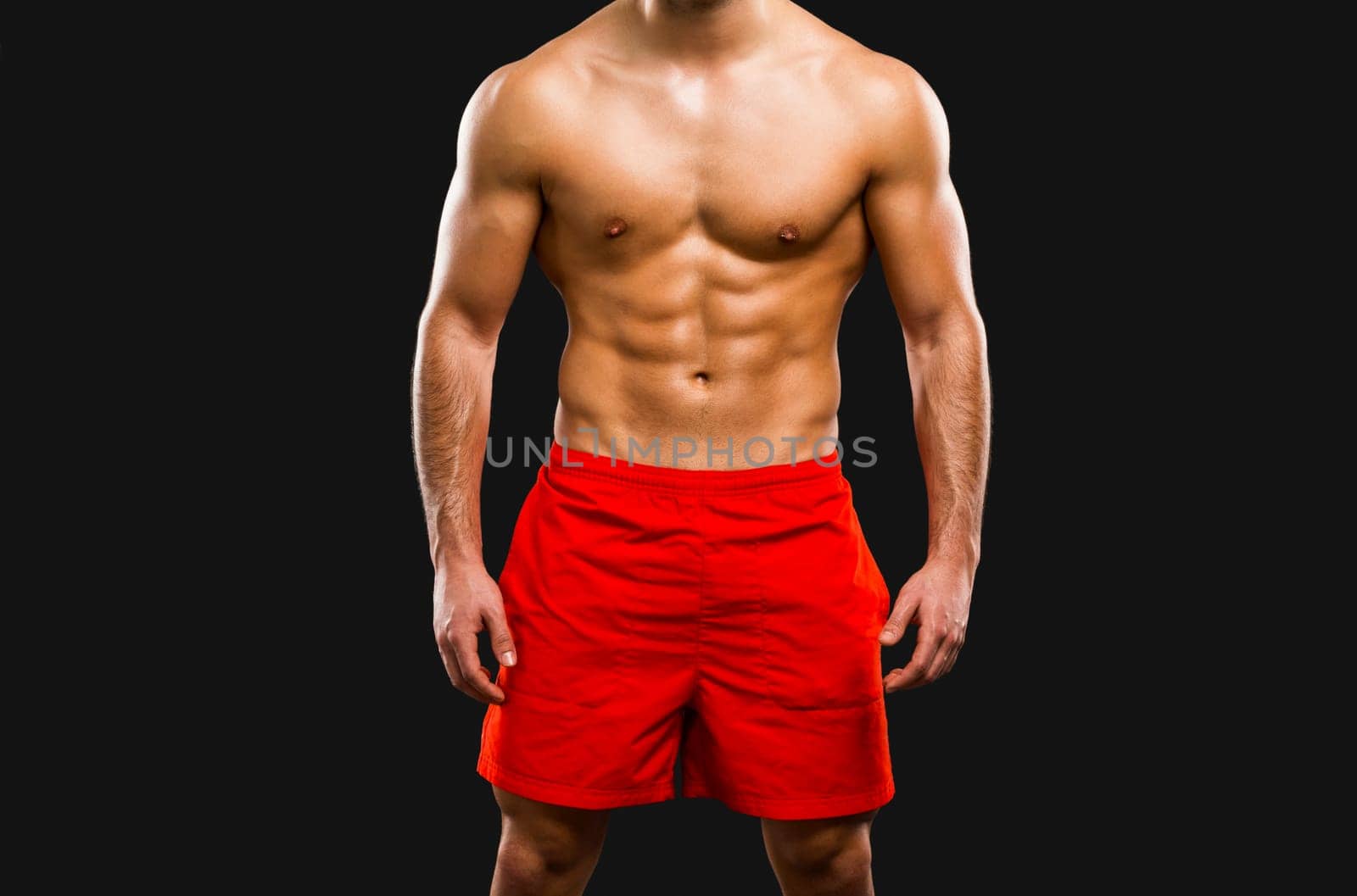 Handsome and sexy muscular man, isolated over gray background