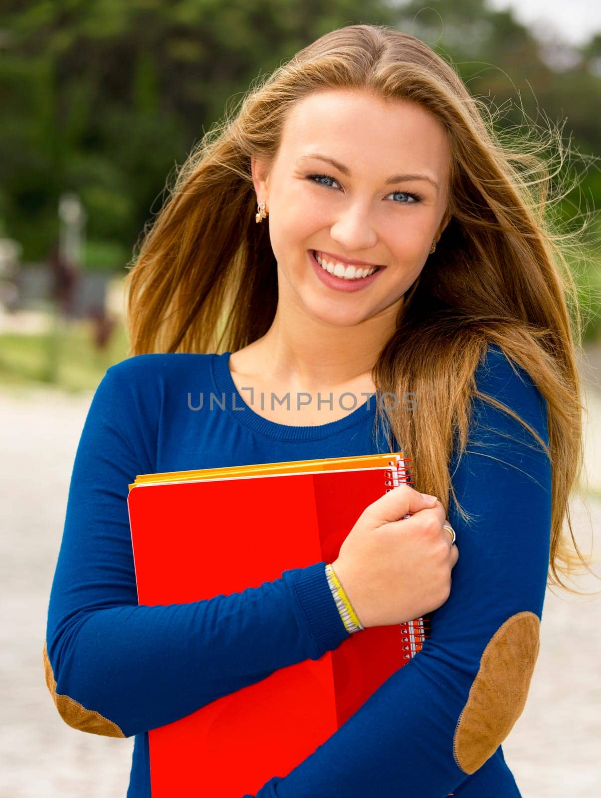 Beautiful and happy teenager student in the school