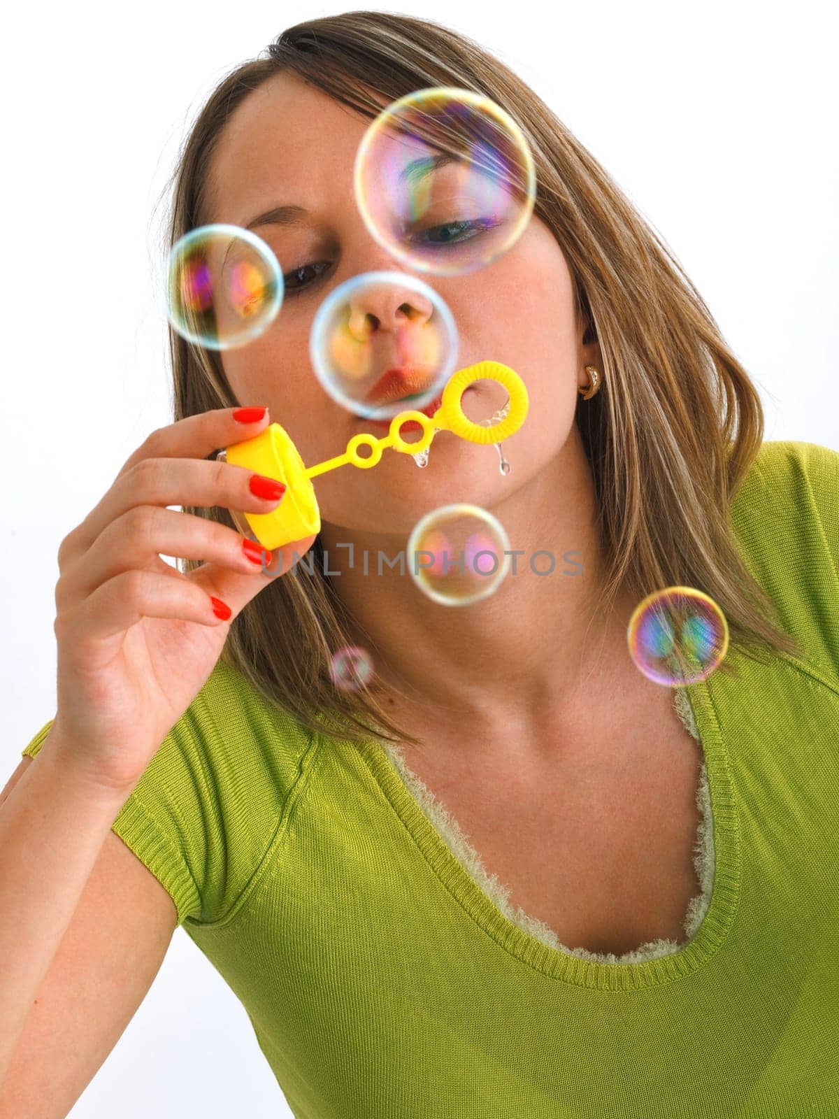 Girl blowing bubbles, isolated on white