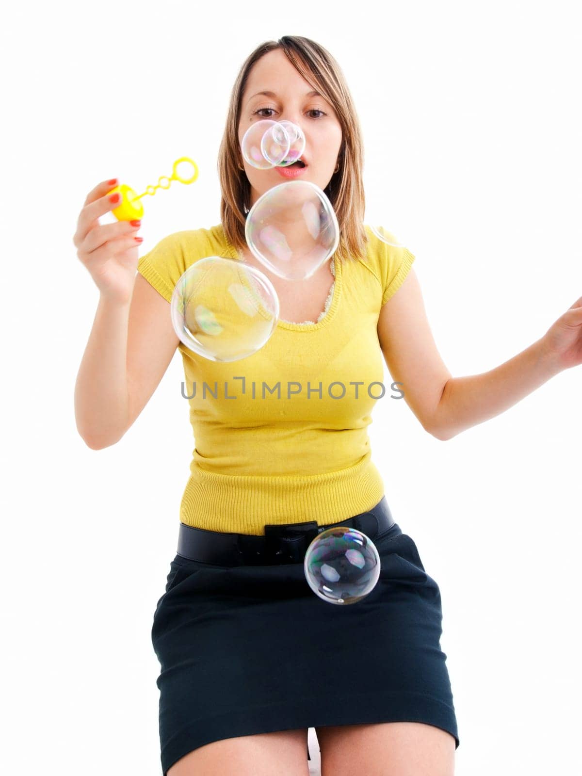 Girl blowing bubbles, isolated on white