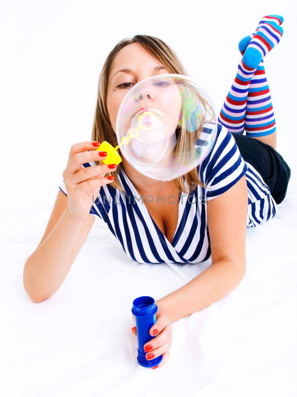 Girl blowing bubbles, isolated on white